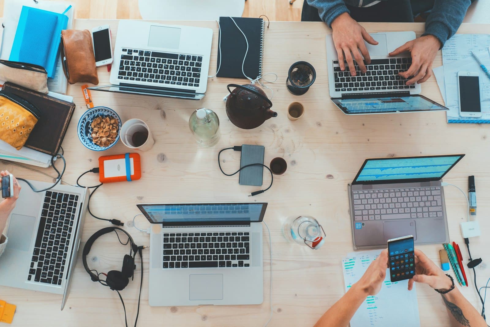 Cross-functional team working together on laptops