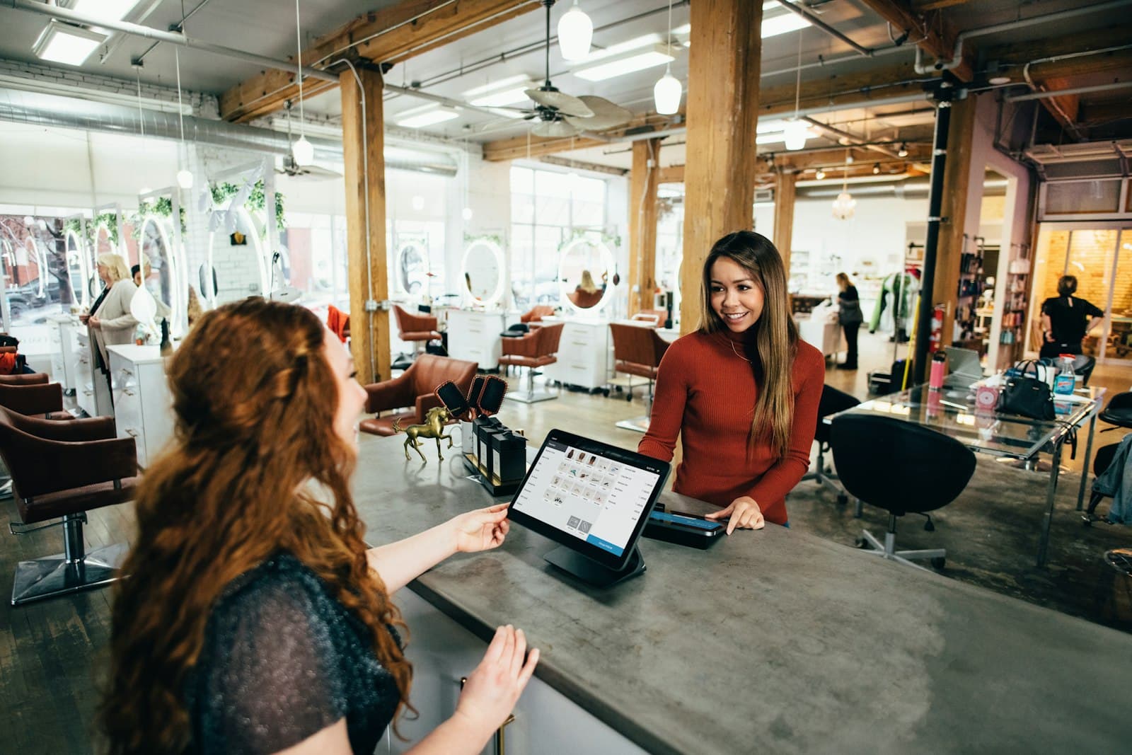 Small business owner helping a customer at the counter